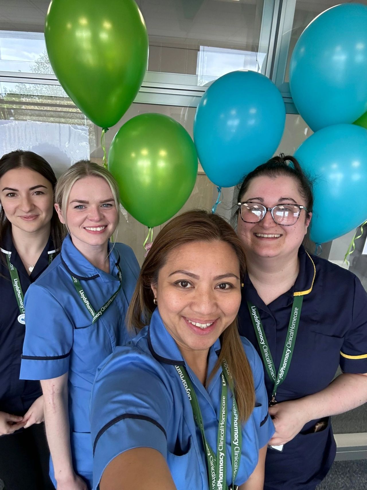 a group of nurses with balloons in the background